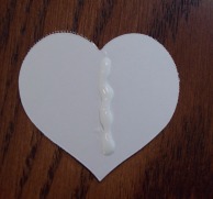 Spread a bead of glue on the back of the heart